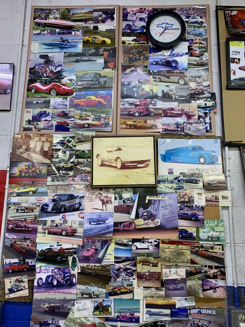 A wall of drag racing photos in the Lindvig Machine shop